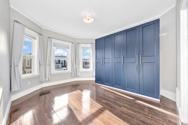 unfurnished bedroom with dark hardwood / wood-style flooring