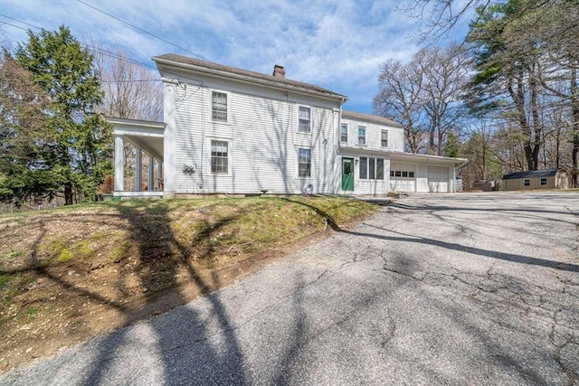 400 N Woodstock Rd, Southbridge, MA 01550 - view of front of property with an attached garage, a chimney, aphalt driveway, and covered porch