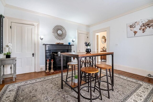 400 N Woodstock Rd, Southbridge, MA 01550 - dining space with a fireplace with flush hearth, wood finished floors, baseboards, and ornamental molding