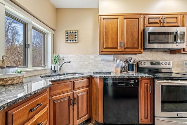 400 N Woodstock Rd, Southbridge, MA 01550 - kitchen featuring backsplash, brown cabinets, dark stone counters, stainless steel appliances, and a sink