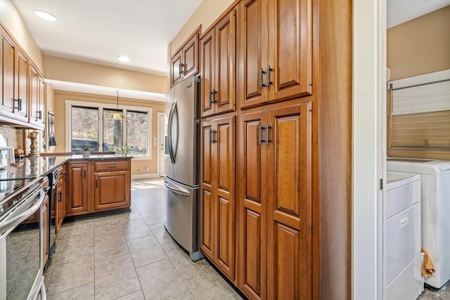 400 N Woodstock Rd, Southbridge, MA 01550 - kitchen featuring a peninsula, brown cabinets, washing machine and clothes dryer, and stainless steel appliances