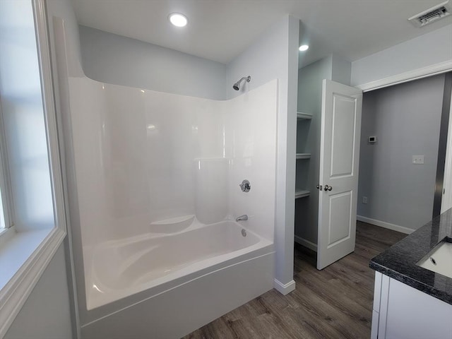 bathroom featuring shower / tub combination, vanity, and wood-type flooring