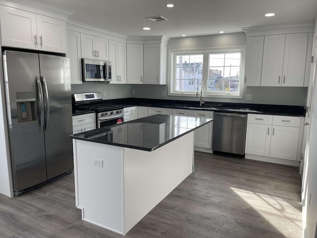 kitchen featuring white cabinets, a kitchen island, and appliances with stainless steel finishes