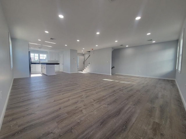 unfurnished living room with dark hardwood / wood-style flooring