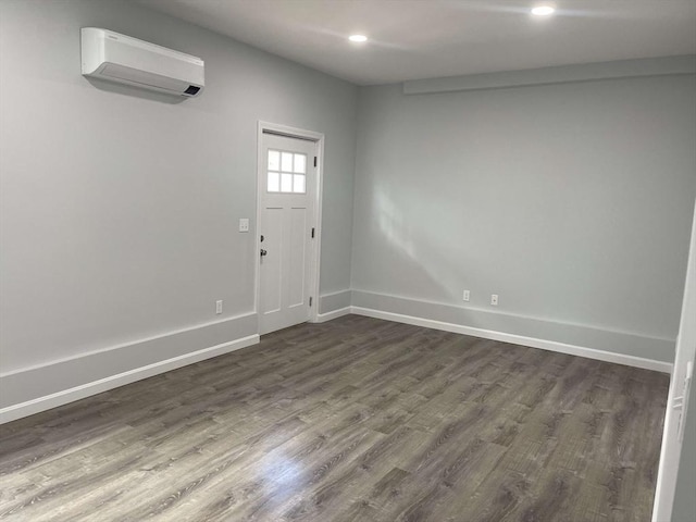 foyer entrance with dark hardwood / wood-style floors and a wall mounted AC