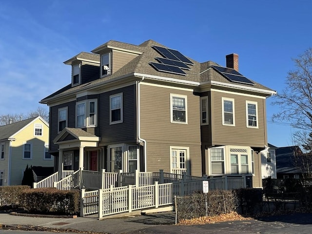 view of front facade with solar panels