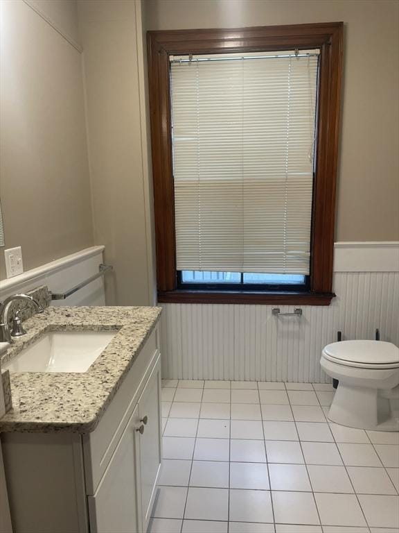 bathroom featuring tile patterned floors, vanity, and toilet