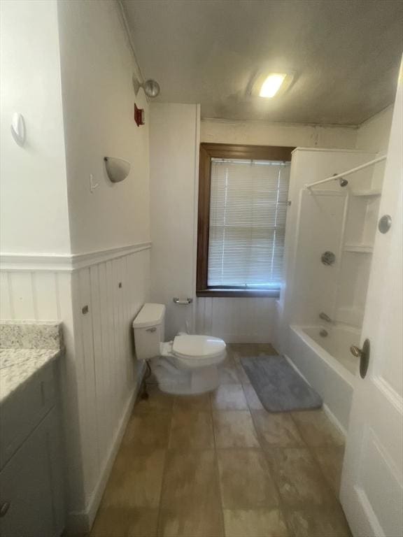 full bathroom featuring vanity, toilet, and washtub / shower combination