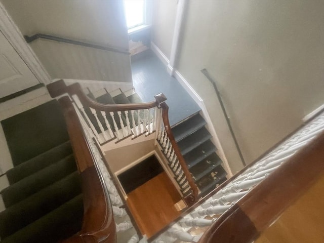 stairs featuring hardwood / wood-style floors