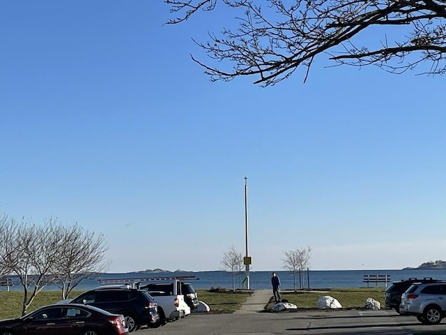 view of parking / parking lot with a water view