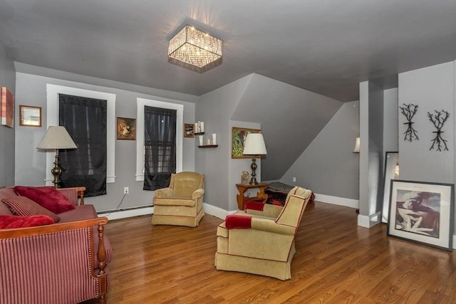 56-A Topliff St, Boston, MA 02122 - living area featuring a baseboard radiator, wood finished floors, a chandelier, and vaulted ceiling