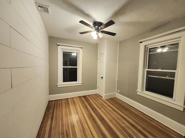 empty room featuring ceiling fan and wood-type flooring