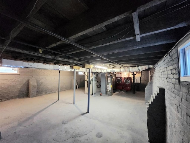 basement with washer and clothes dryer and water heater