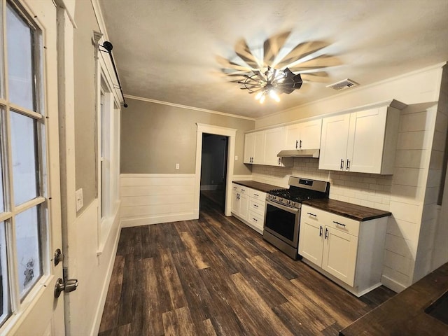 kitchen featuring ornamental molding, dark hardwood / wood-style floors, stainless steel range with gas stovetop, and white cabinets