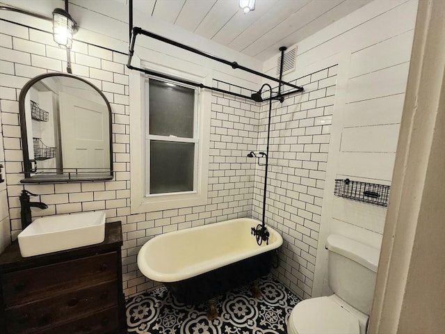 full bathroom with vanity, separate shower and tub, tile walls, and toilet