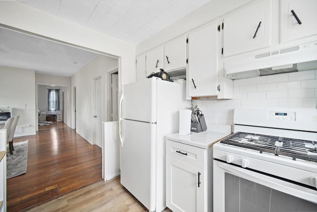 90 Montaup St, Fall River, MA 02724 - kitchen with white appliances, decorative backsplash, light wood-type flooring, under cabinet range hood, and white cabinets