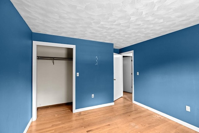 5 Glad St, Freetown, MA 02702 - unfurnished bedroom with wood finished floors, a textured ceiling, a closet, and baseboards