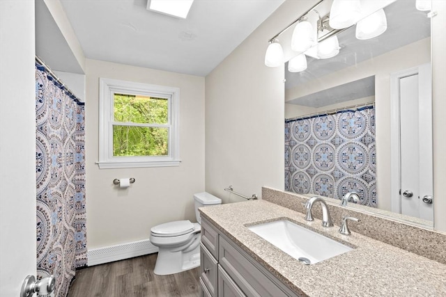 5 Glad St, Freetown, MA 02702 - bathroom featuring baseboard heating, toilet, wood finished floors, vanity, and baseboards