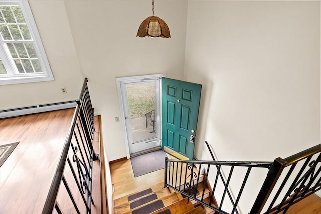 5 Glad St, Freetown, MA 02702 - foyer featuring a towering ceiling, wood finished floors, a baseboard heating unit, and baseboards