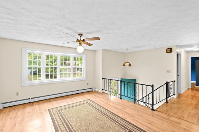 5 Glad St, Freetown, MA 02702 - spare room featuring a baseboard radiator, ceiling fan, wood finished floors, baseboards, and a textured ceiling