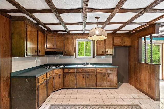 5 Glad St, Freetown, MA 02702 - kitchen featuring a sink, coffered ceiling, dark countertops, stainless steel gas stovetop, and wood walls
