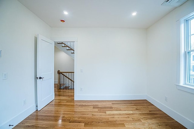 spare room with recessed lighting, baseboards, light wood-type flooring, and visible vents