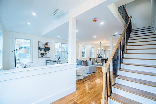 stairs with recessed lighting, visible vents, and wood finished floors