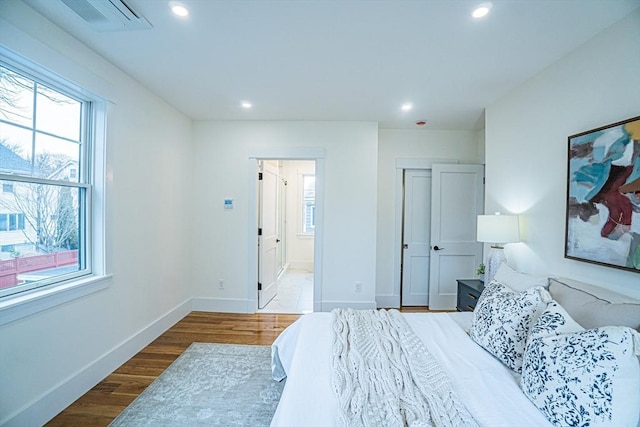 bedroom featuring recessed lighting and multiple windows