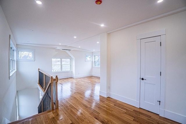 spare room featuring recessed lighting, wood finished floors, and a healthy amount of sunlight