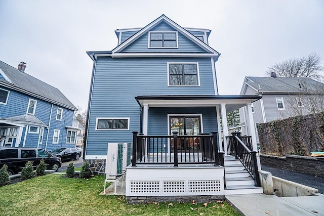 exterior space featuring a porch and a front yard