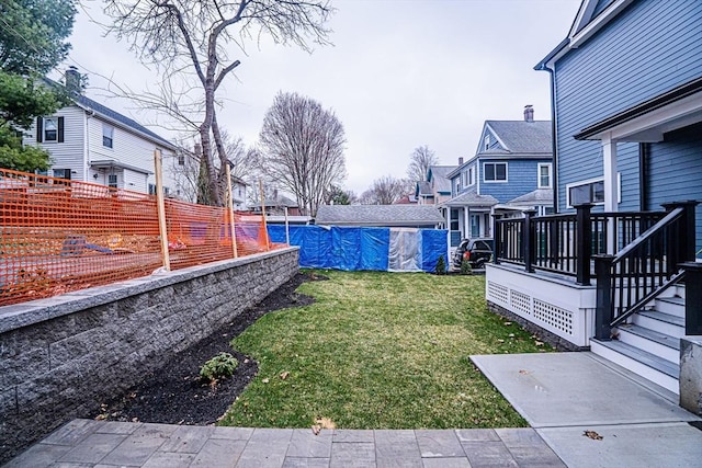 view of yard with a fenced in pool, a residential view, and a fenced backyard