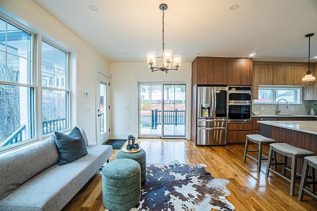 living room with plenty of natural light and light wood-style flooring