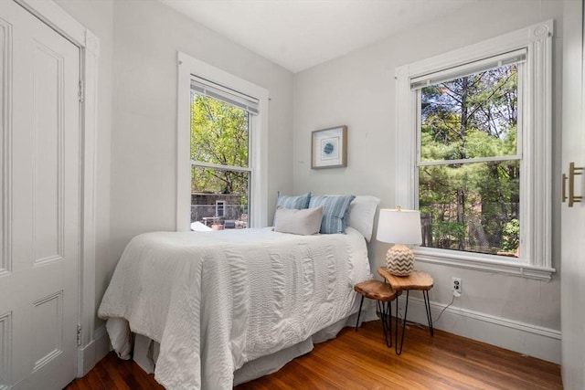 bedroom featuring baseboards and wood finished floors