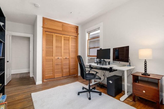 office space featuring baseboards and wood finished floors