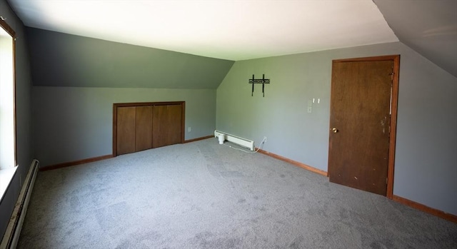 bonus room featuring baseboards, lofted ceiling, a baseboard heating unit, and light carpet