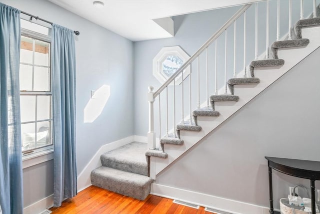 stairway with hardwood / wood-style floors