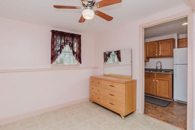 interior space with baseboards and a ceiling fan