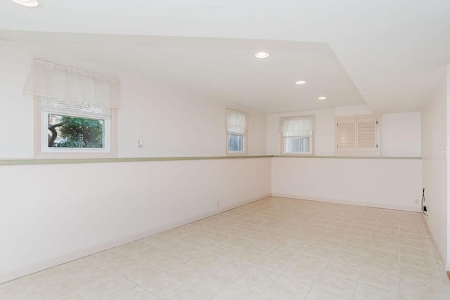 unfurnished room with recessed lighting and baseboards