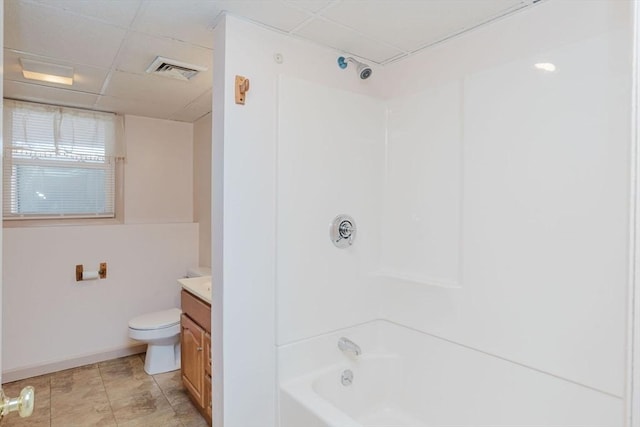 bathroom featuring visible vents, toilet, a drop ceiling, shower / bathing tub combination, and vanity