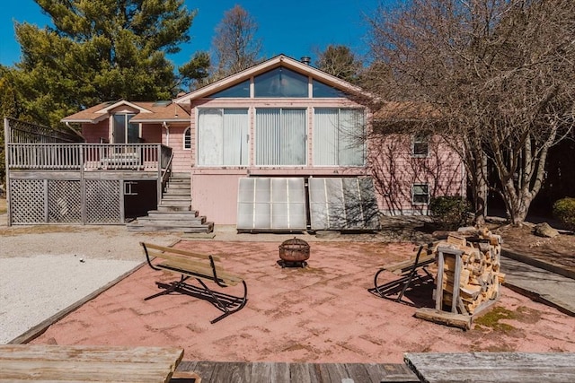 exterior space with stairway and an outdoor fire pit