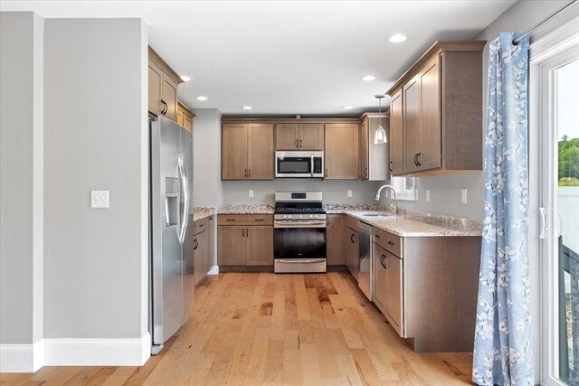 194B Narrows Rd, Westminster, MA 01473 - kitchen with stainless steel appliances, light wood finished floors, light stone counters, a sink, and recessed lighting