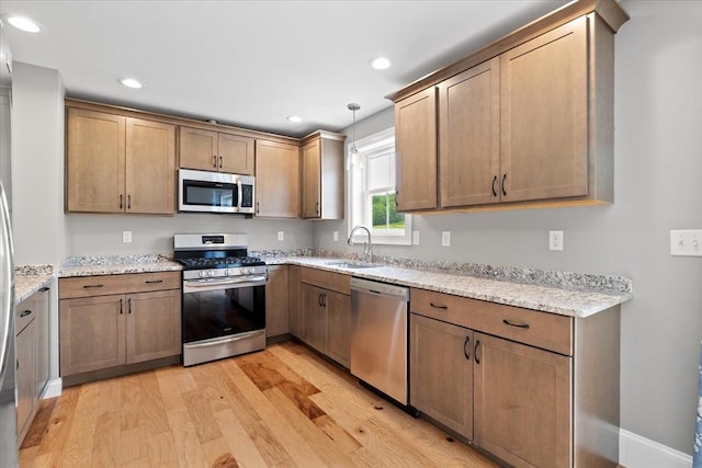 194B Narrows Rd, Westminster, MA 01473 - kitchen with appliances with stainless steel finishes, light wood-style floors, a sink, light stone countertops, and recessed lighting