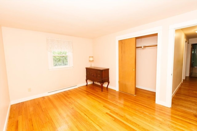 460 Front St, Weymouth, MA 02188 - unfurnished bedroom featuring light wood-style floors, a baseboard heating unit, a closet, and baseboards