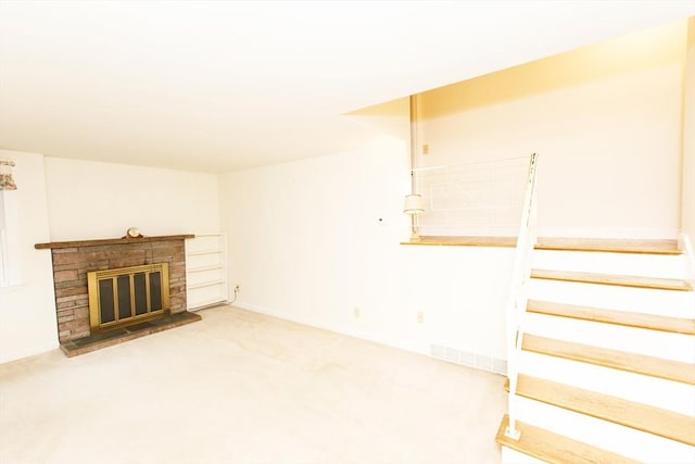 460 Front St, Weymouth, MA 02188 - unfurnished living room with carpet flooring, a brick fireplace, stairs, and baseboards