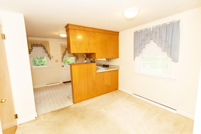 460 Front St, Weymouth, MA 02188 - kitchen with baseboard heating, a peninsula, light carpet, brown cabinets, and baseboards