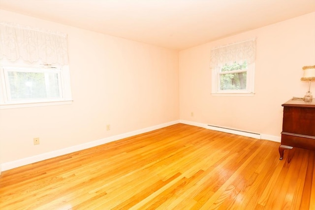 460 Front St, Weymouth, MA 02188 - empty room featuring a baseboard heating unit, wood finished floors, and baseboards