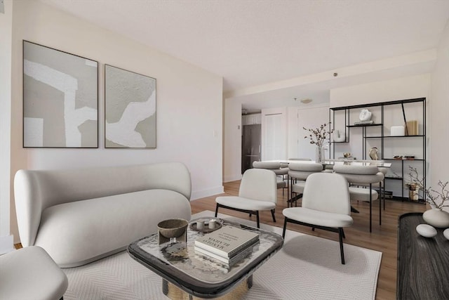 living room featuring wood finished floors and baseboards