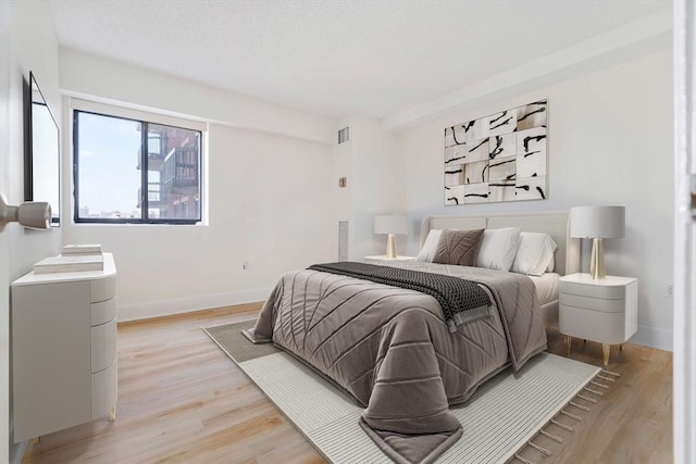bedroom with baseboards and light wood-style floors