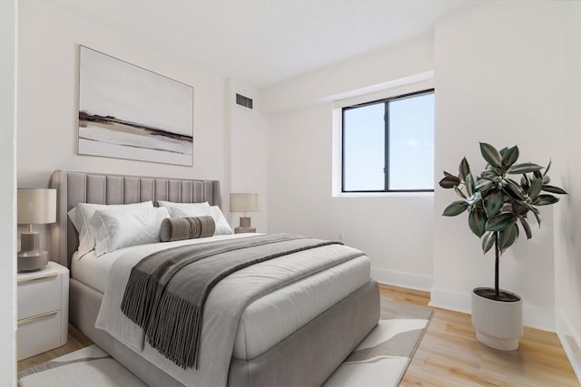 bedroom featuring light wood-type flooring and baseboards