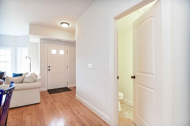 foyer featuring light wood-type flooring and baseboards